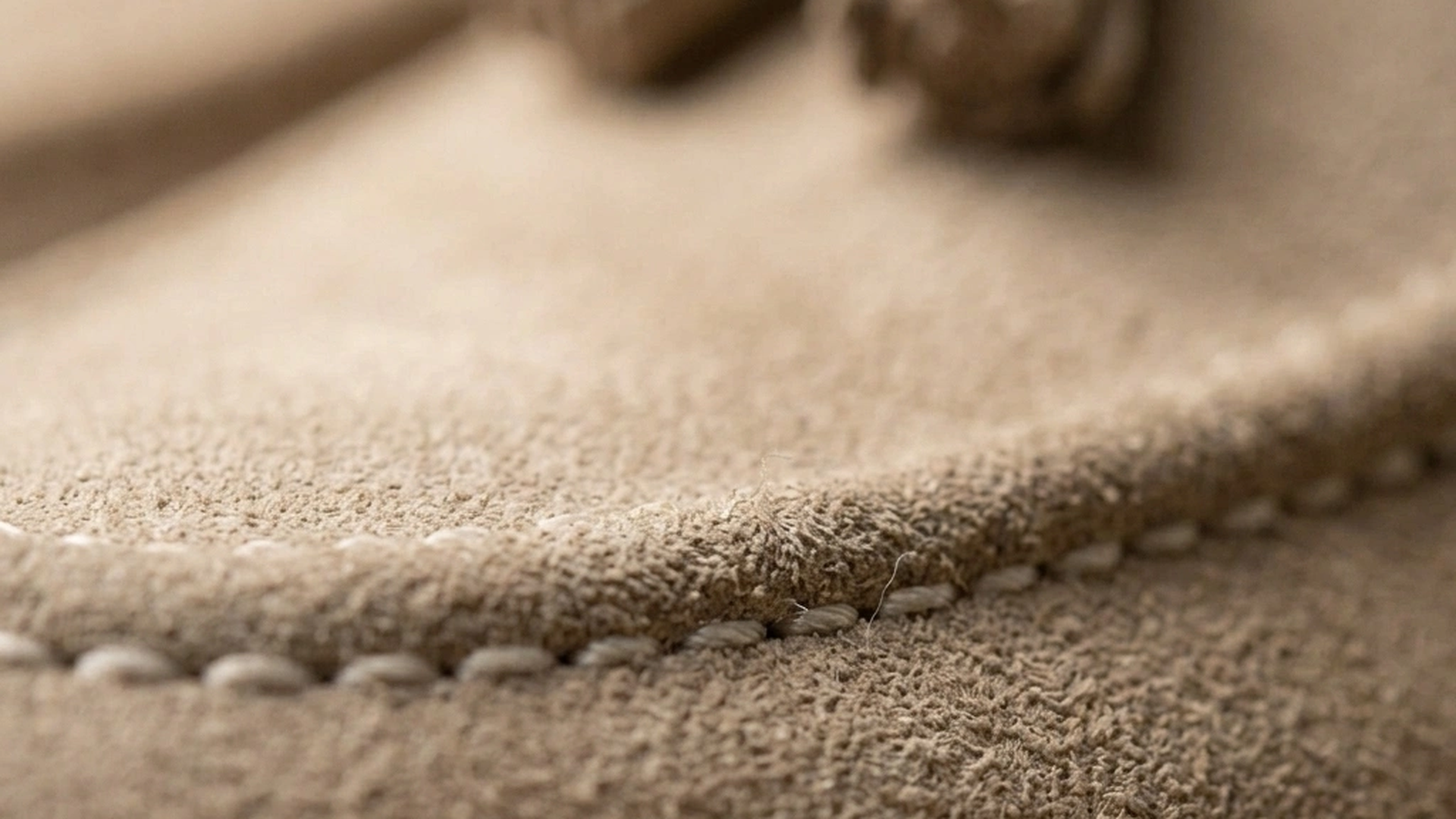 Signature hand-knotted tassels on the suede vamp